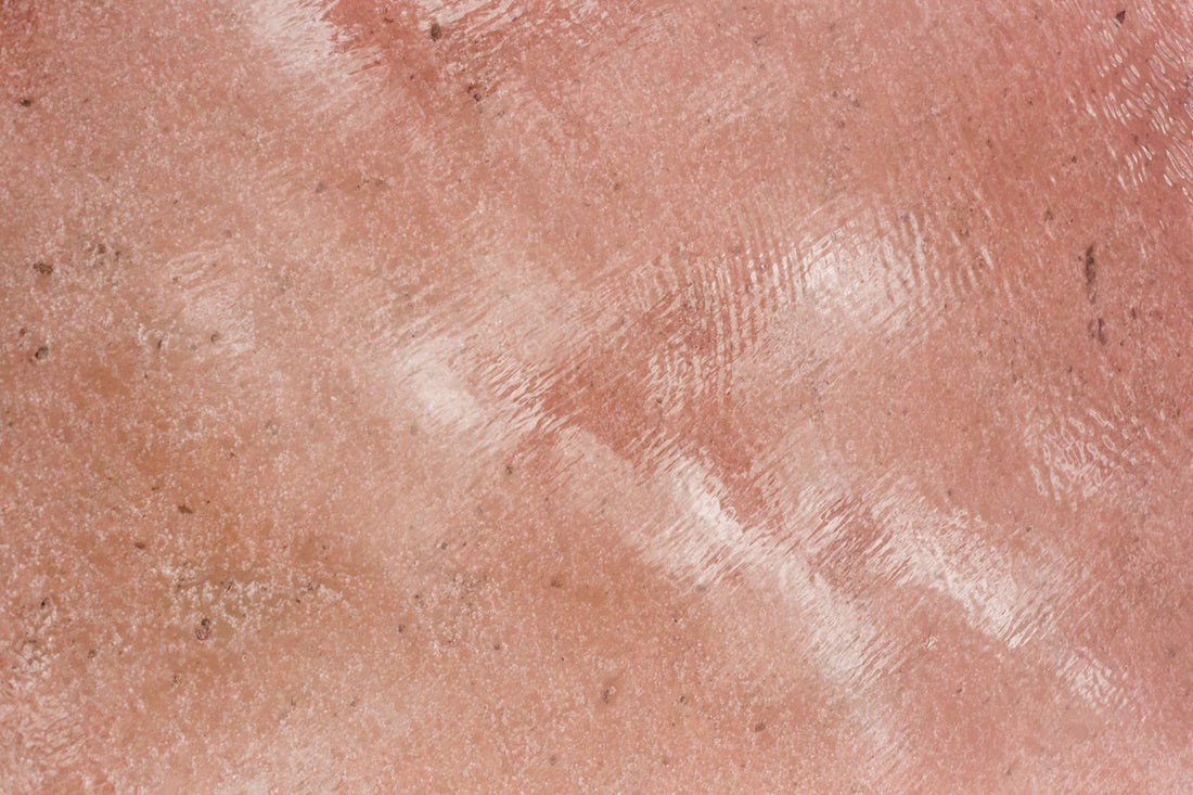 Textured pink surface with a reflective shine.